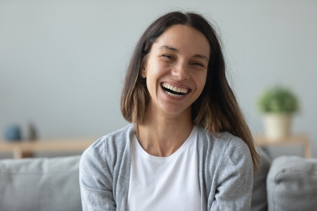 Headshot portrait laughing 30s woman looking at camera